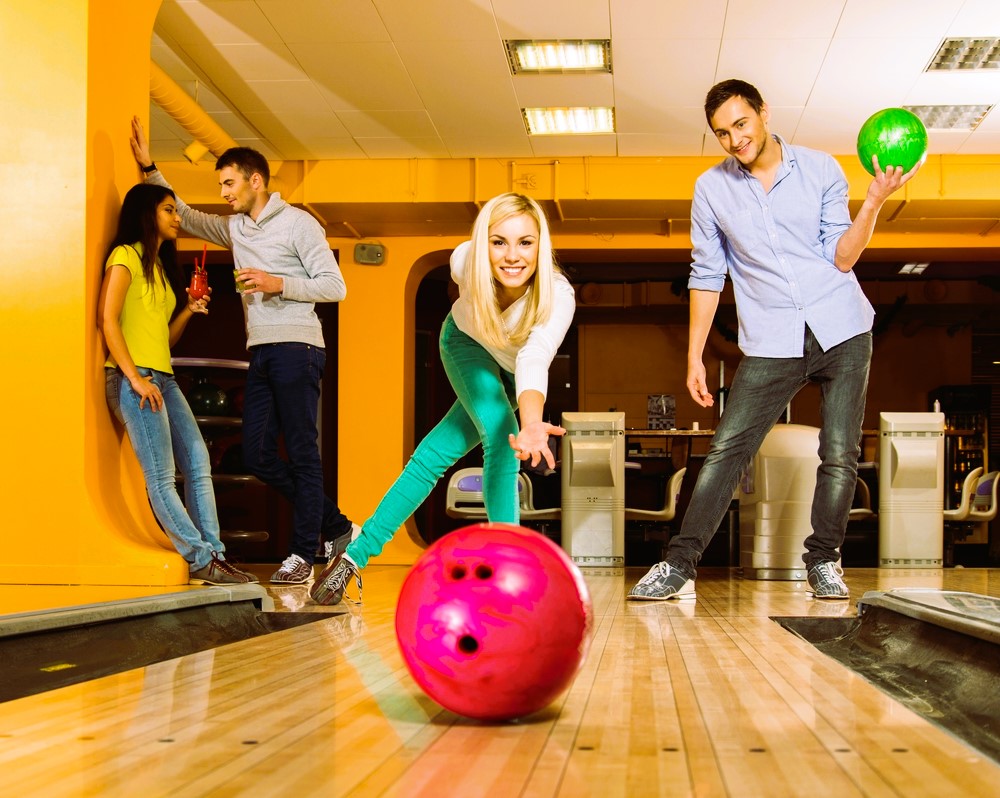 Blond smiling girl throwing ball